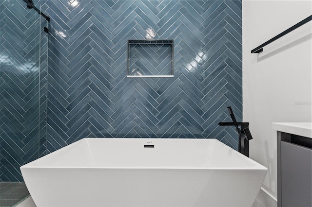 bathroom featuring tile patterned flooring, vanity, and a bathtub