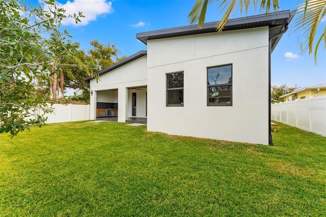 rear view of property with a lawn and french doors