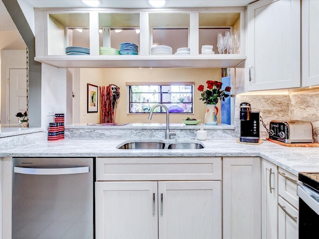 kitchen with sink, white cabinets, dishwasher, and light stone counters