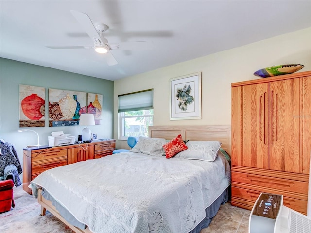 tiled bedroom featuring ceiling fan