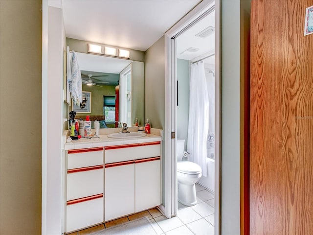 full bathroom with shower / bathtub combination with curtain, tile patterned flooring, toilet, vanity, and ceiling fan