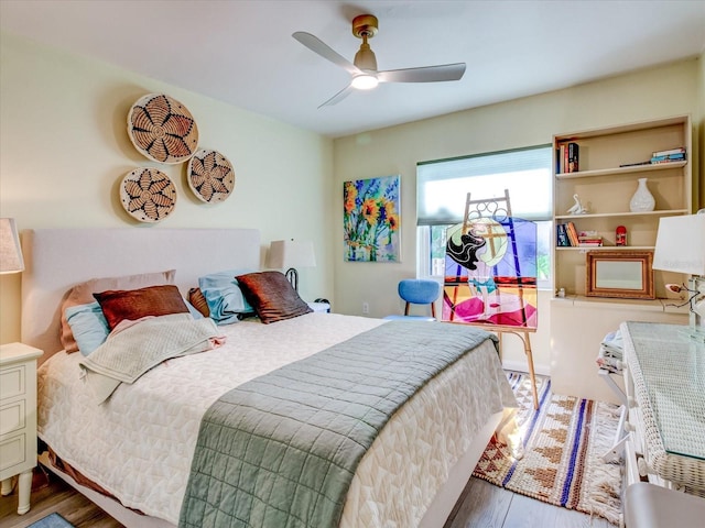 bedroom with ceiling fan and hardwood / wood-style floors