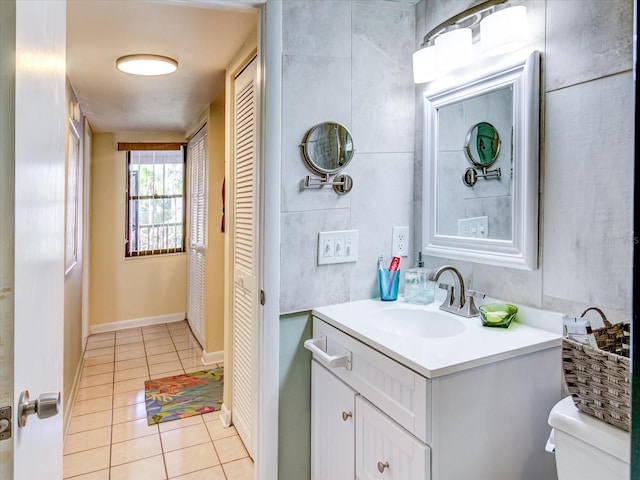 bathroom featuring tile patterned flooring, vanity, and toilet