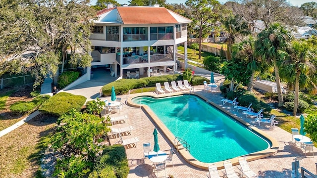 view of swimming pool with a patio and a sunroom