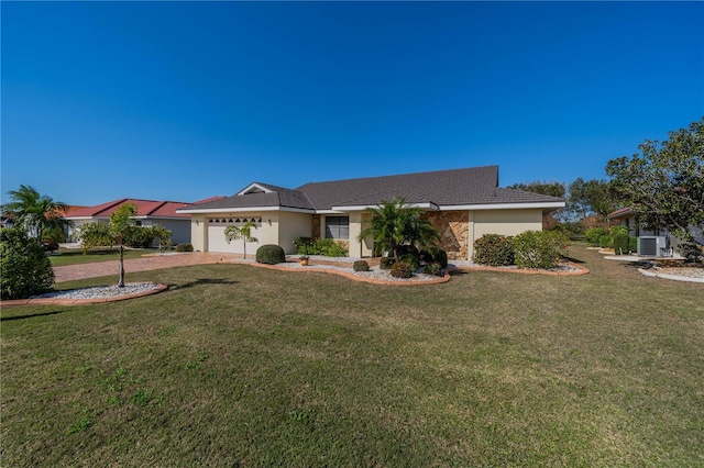 single story home with a garage, central air condition unit, and a front yard