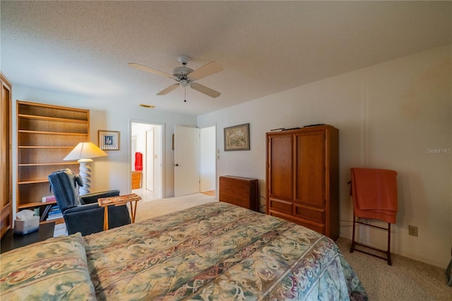 carpeted bedroom featuring a textured ceiling and ceiling fan