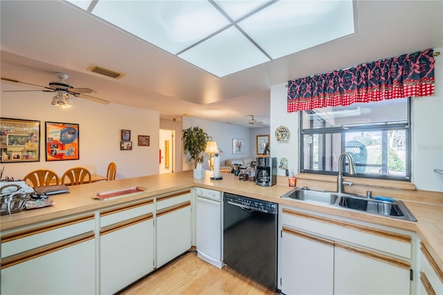 kitchen with white cabinetry, dishwasher, sink, ceiling fan, and kitchen peninsula