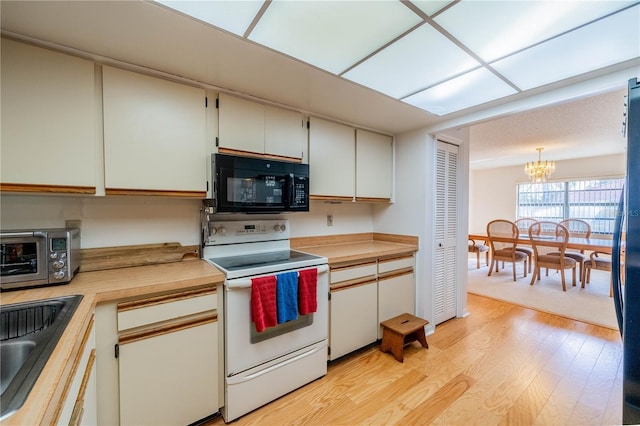 kitchen with decorative light fixtures, white cabinetry, sink, white electric range oven, and light wood-type flooring