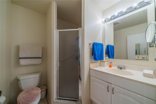 bathroom featuring a shower with door, vanity, and toilet