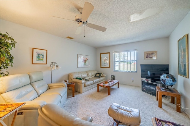 living room with ceiling fan, light carpet, and a textured ceiling