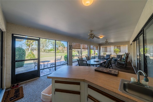 sunroom / solarium featuring sink