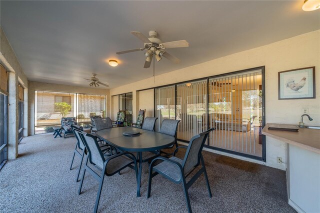 sunroom / solarium with ceiling fan and sink