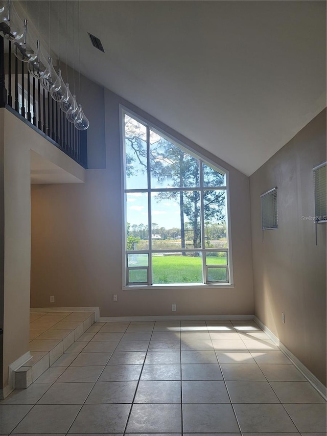 tiled empty room with high vaulted ceiling