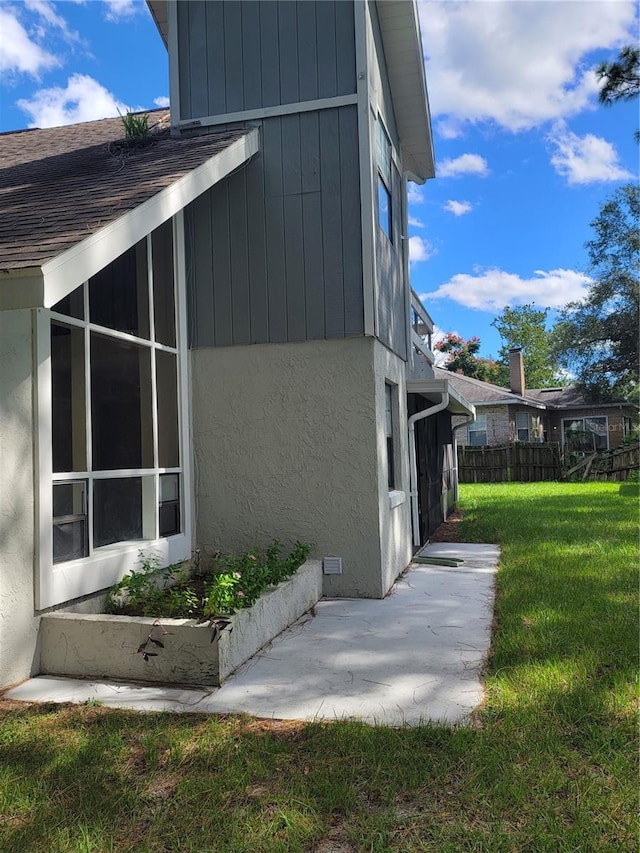 view of property exterior featuring a yard and a patio area