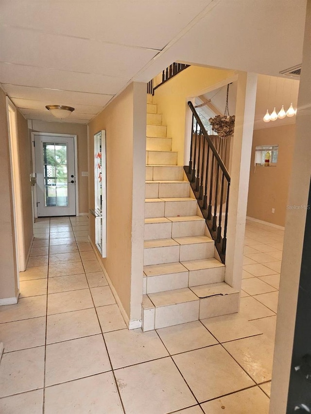 stairway featuring tile patterned flooring