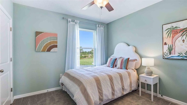 bedroom with ceiling fan and dark colored carpet