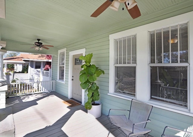 wooden terrace with covered porch and ceiling fan