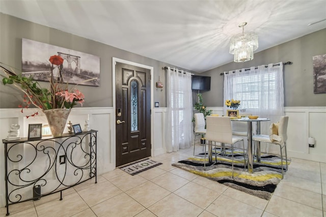 interior space with a chandelier and vaulted ceiling