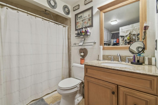 bathroom featuring tile patterned floors, vanity, and toilet