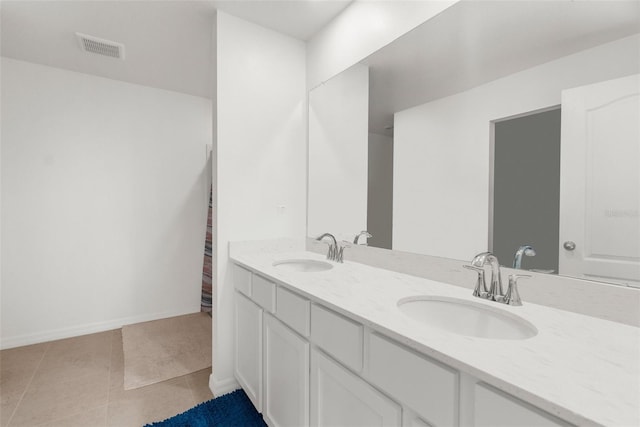 bathroom with tile patterned floors and vanity