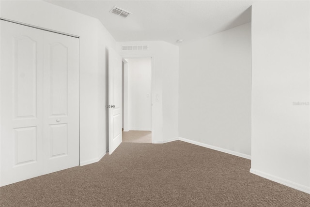 unfurnished bedroom featuring a closet and carpet floors