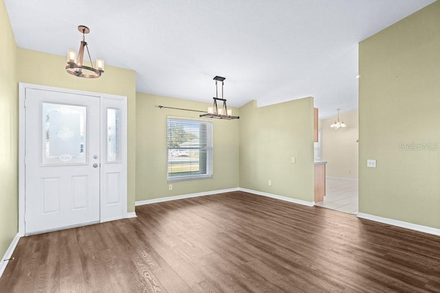 entryway with hardwood / wood-style flooring and an inviting chandelier