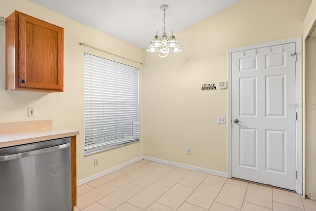 unfurnished dining area with a chandelier and light tile patterned flooring