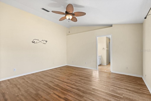 spare room with light wood-type flooring, ceiling fan, and lofted ceiling