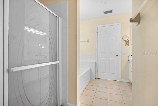 bathroom with tile patterned flooring and independent shower and bath