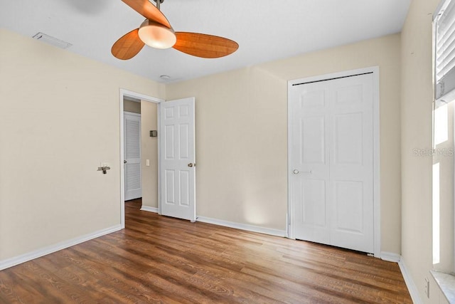 unfurnished bedroom featuring wood-type flooring, a closet, and ceiling fan