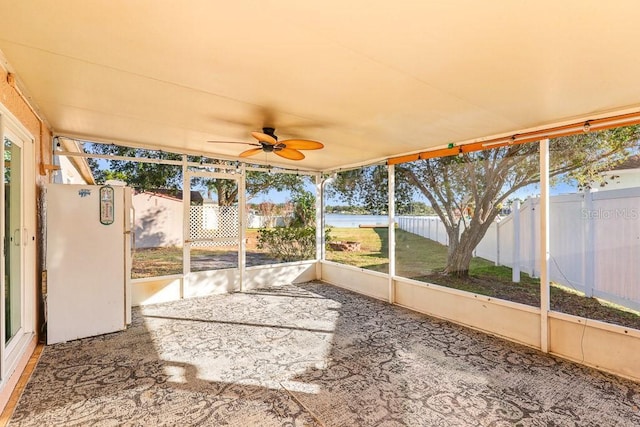 unfurnished sunroom featuring ceiling fan