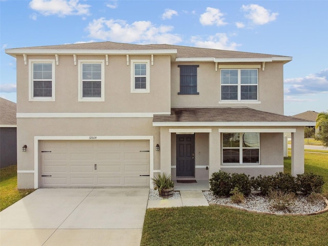 view of front of property featuring a garage and a front yard