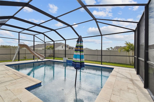 view of swimming pool featuring a patio area, a lanai, and a water slide