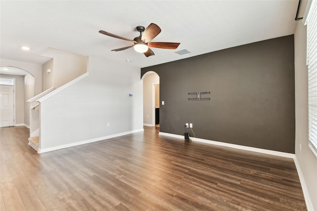 empty room with hardwood / wood-style floors and ceiling fan