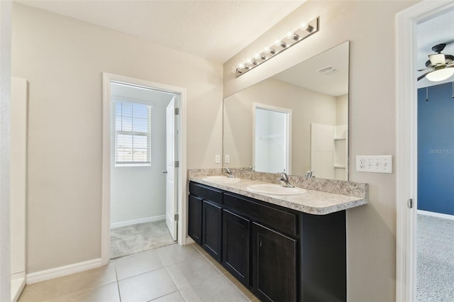 bathroom featuring tile patterned floors, vanity, and ceiling fan