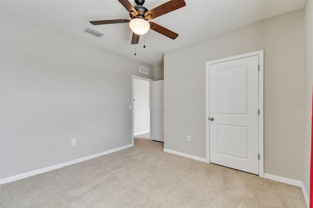 unfurnished bedroom featuring ceiling fan and light colored carpet