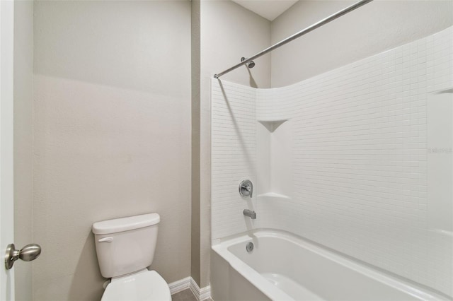 bathroom featuring toilet and bathing tub / shower combination