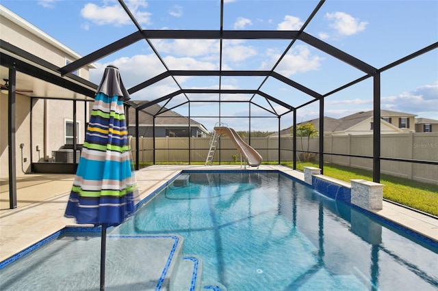 view of pool featuring pool water feature, a patio area, a lanai, and a water slide