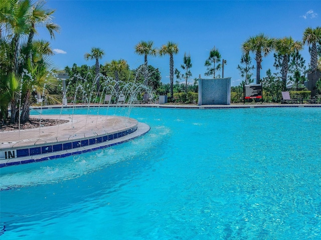 view of swimming pool with pool water feature