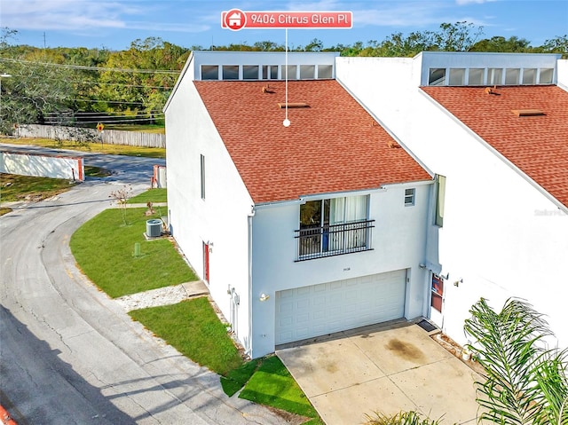 view of front facade with central AC unit and a garage