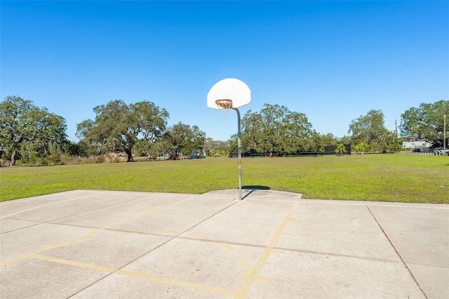 view of sport court featuring a yard