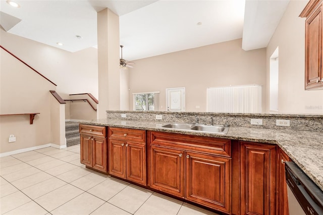 kitchen featuring sink, stainless steel dishwasher, ceiling fan, light stone counters, and light tile patterned floors