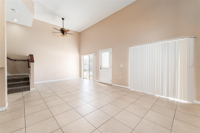 unfurnished living room with high vaulted ceiling, light tile patterned flooring, and ceiling fan