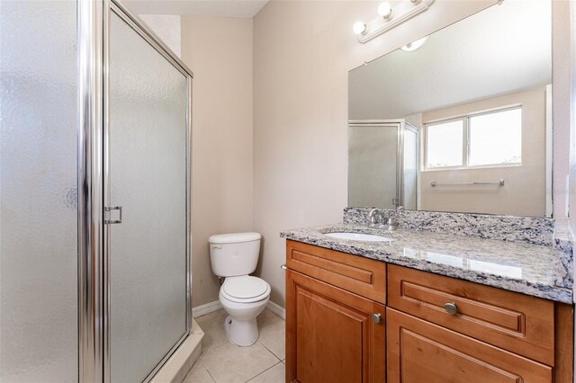 bathroom with toilet, a shower with door, tile patterned flooring, and vanity