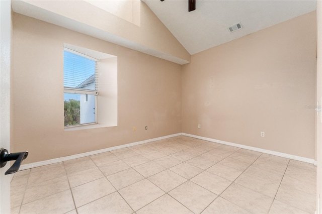 tiled empty room with vaulted ceiling and ceiling fan