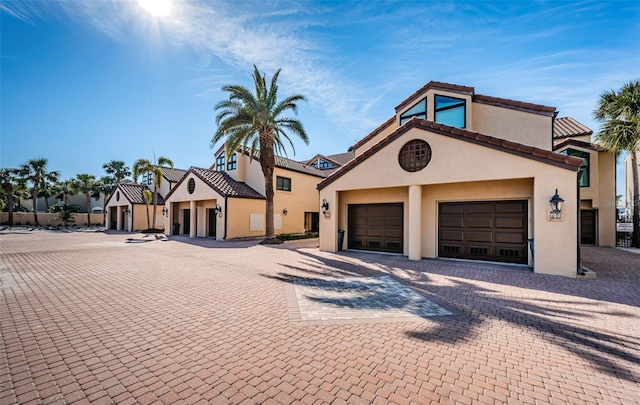 mediterranean / spanish home with a garage