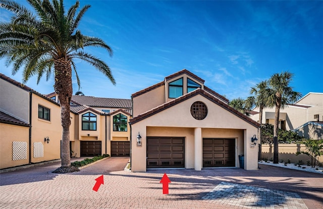 mediterranean / spanish house featuring a garage