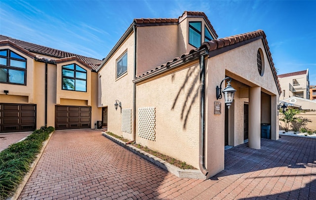 view of side of home featuring a garage