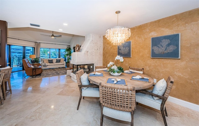 dining room featuring lofted ceiling and ceiling fan with notable chandelier