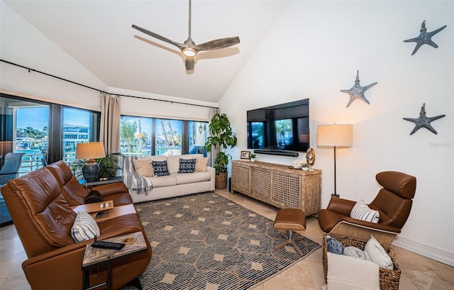 living room with ceiling fan and high vaulted ceiling